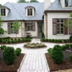 A house with a circular driveway and landscaping.