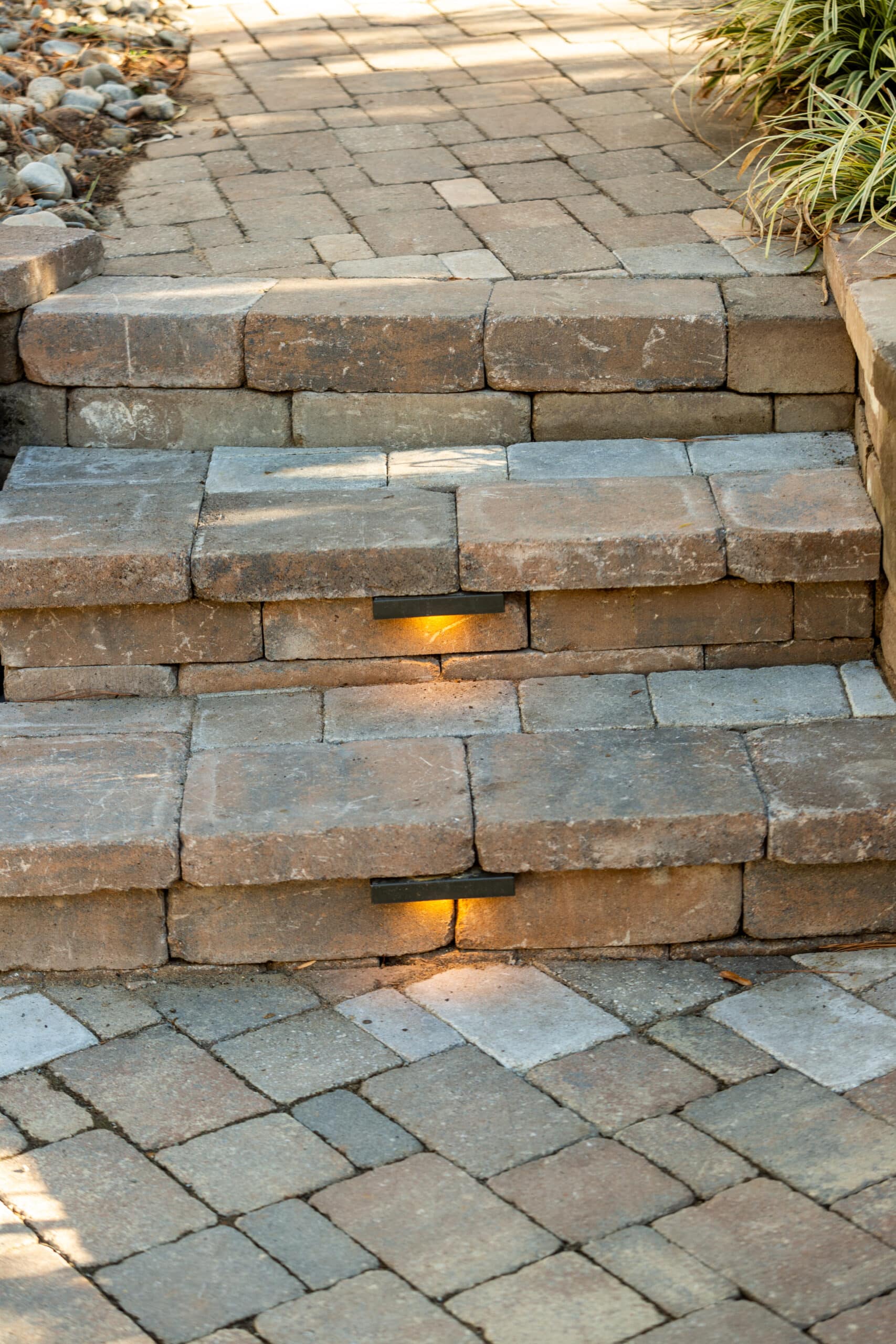 A set of steps leading to a stone walkway.