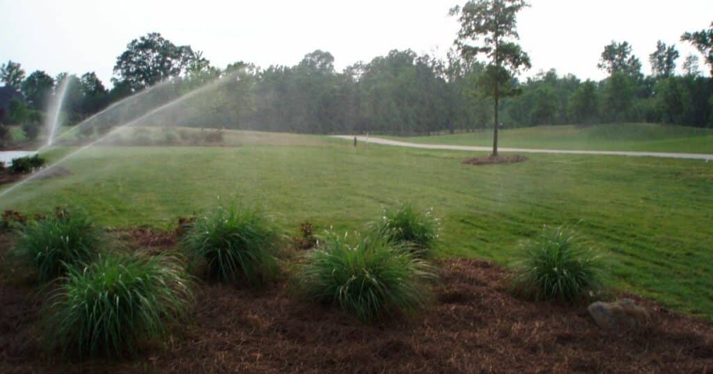 Irrigation - A sprinkler is spraying water on a lawn.