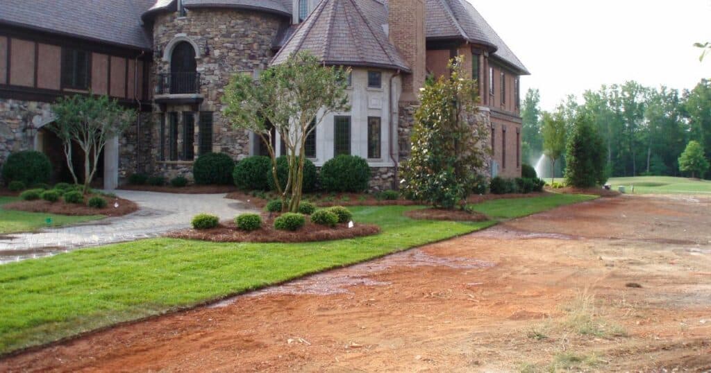 A large house with a driveway and landscaping.
