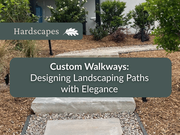 Stone walkway bordered by mulch and plants leads to a house entrance; overlaid text reads, "Custom Walkways: Designing Landscaping Paths with Elegance.