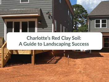 A house under construction with a red dirt area.