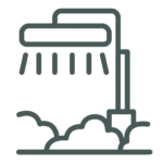 Line drawing of a showerhead spraying water above a shovel and a pile of dirt or dust.