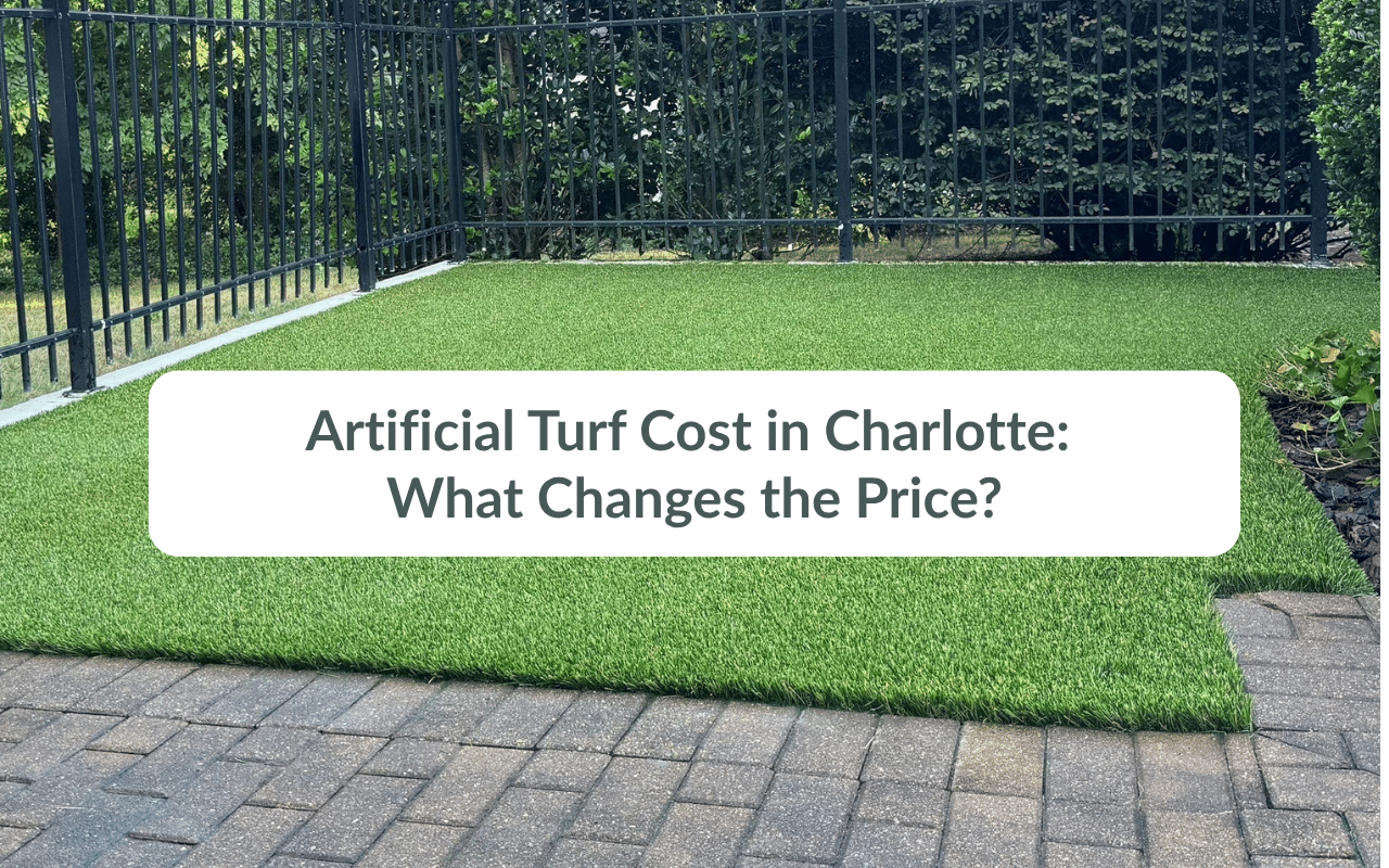 A small backyard with artificial turf bordered by a black metal fence and brick pavers, overlaid with text about turf cost in Charlotte—perfect inspiration for HOA landscaping Charlotte or general landscaping Charlotte NC projects.