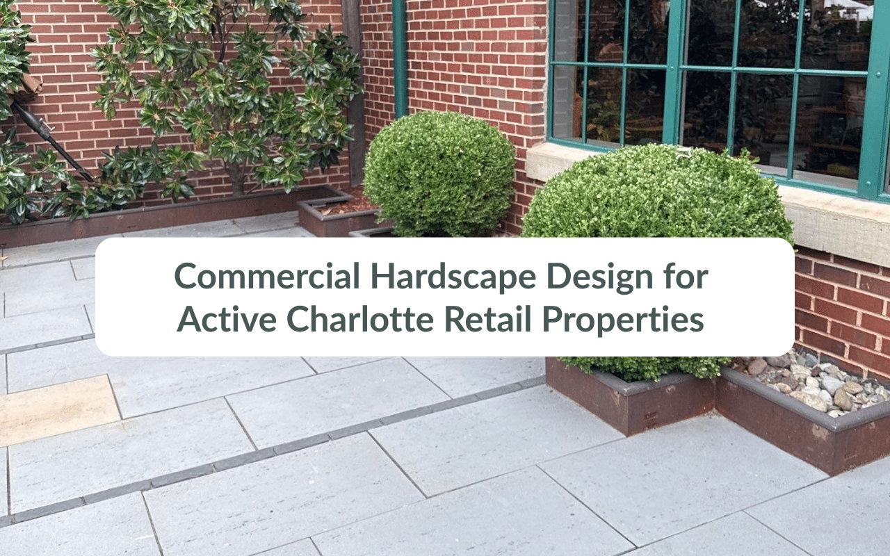 Brick building exterior with gray stone pavers and potted shrubs, showcasing commercial property maintenance in Charlotte, with text: “Commercial Hardscape Design for Active Charlotte Retail Properties.”